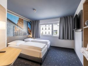 Postel nebo postele na pokoji v ubytování B&B Hotel Schweinfurt-City + 22 fotografií