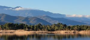 a view of a lake with mountains in the background at CASA DI SIGNARE in Ventiseri