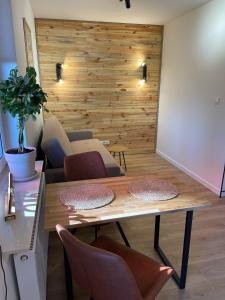 a dining room with a wooden table and chairs at Wooden Dream with Terrace in Siedlce +6 photos