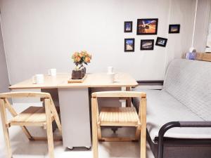 a room with a table and two chairs and a bed at Sweet Home in Seoul +9 photos