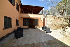 a patio with chairs in front of a building at AIR B&B PLEASANT MOMENTS in Bolsena