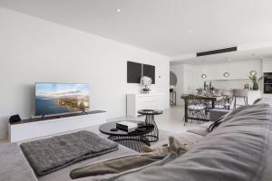 a living room with a couch and a tv on a wall at ViVi Homes - Casa Española in Fuengirola
