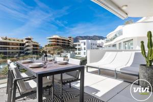a patio with a table and chairs on a balcony at ViVi Homes - Casa Española in Fuengirola