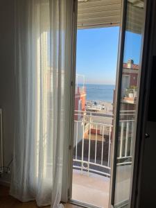a room with a view of the ocean from a balcony at Appartamento Vacanze ACQUA E SALE in Marotta