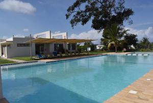 a large swimming pool in front of a house at Lihanda Villa in Kilifi
