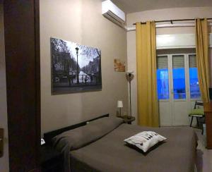 a bedroom with a bed and a picture on the wall at Suite beachfront near the station and Port, 5 beds in Civitavecchia