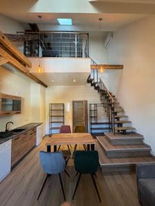 a kitchen and dining room with a wooden table and stairs at Pinnerbergstube Ferienwohnung Cochem Mosel in Cochem