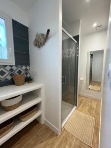 a bathroom with a shower with a glass door at Studio cosy in Frontignan +17 photos