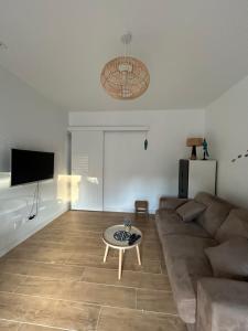 a living room with a couch and a coffee table at Studio cosy in Frontignan