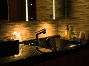 a kitchen sink with a faucet in a kitchen at OceanVilla Naruto in Naruto +16 photos