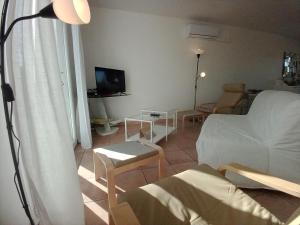 a living room with a bed and a couch and a table at villa 2 chambres en rez-de-jardin in Puylaurens