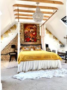 a bedroom with a bed with a yellow bedspread at Golspie House, Margate in Margate