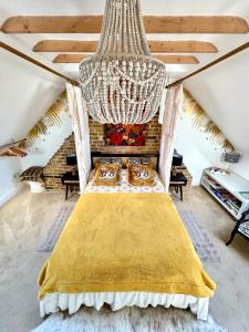 a bed in a room with a chandelier at Golspie House, Margate in Margate +46 photos