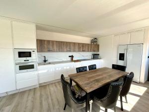 a kitchen with a wooden table and chairs in it at Liberté in Mazarrón