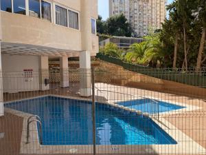 a swimming pool in front of a building at Torres Gardens-Fincas Benidorm in Benidorm