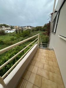 a balcony with a view of a field at Agiazi Vacation Rooms Pitsidia in Pitsidia