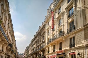 a building on a street in a city at Hotel Cervantes by Happyculture in Paris +33 photos