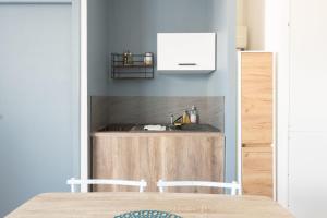 a kitchen with a sink and a counter at TERRASSE DU MAINE - Centre ville - Wifi in Saint-Nazaire +5 photos