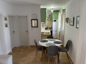a kitchen and dining room with a table and chairs at Apartment Dino in Splitska +23 photos