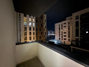 a view of a city at night from a balcony at Apartament me qera Gjilan,te sheshi in Gjilan