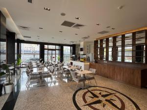 a restaurant with tables and chairs and windows at İstanblu Hotel&Spa in Konak