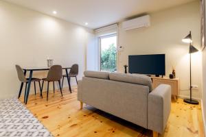 a living room with a couch and a table at Luxury Style 6 with AC Downtown Porto near Metro in Porto