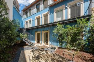 a blue building with benches in front of it at Luxury Style 6 with AC Downtown Porto near Metro in Porto
