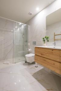 a bathroom with a shower and a toilet and a sink at Luxury Style 6 with AC Downtown Porto near Metro in Porto