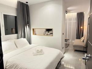 a hotel room with a bed with two towels on it at Karma - Luxury Living in Katerini