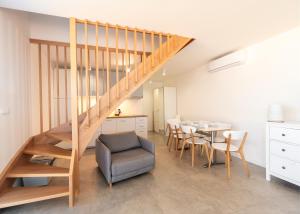a kitchen and dining room with a staircase and a table at Letnisko Jastarnia in Jastarnia