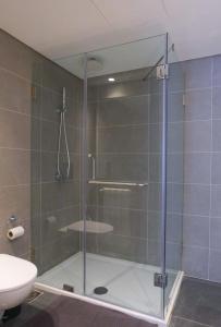 a shower with a glass door in a bathroom at High-End Loft in Gemmayze in Beirut