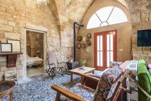 a living room with a stone wall at Les Galets in Batroun in Batroûn