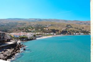 an aerial view of a beach with buildings and houses at Chic Magnificent Sea View Suite in Andros