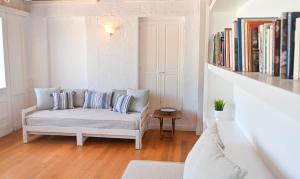 a living room with a couch and a book shelf at Chic Magnificent Sea View Suite in Andros +6 photos