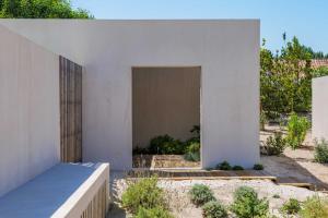 a facade of a white building with a doorway at Pure Bungalow in Carvalhal
