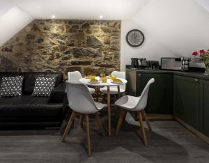 a living room with a table and a couch at Castle Street Apartments - Luxury Kilchattan Apartment in Rothesay