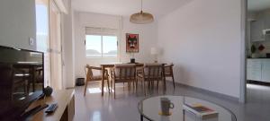 a living room with a table and chairs and a dining room at Apartamento en Playa Honda - La Manga in Cartagena