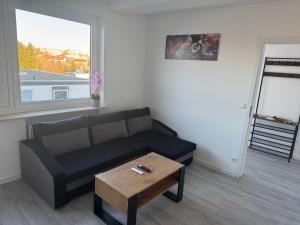 a living room with a couch and a coffee table at Ferienwohnung VS in Villingen-Schwenningen
