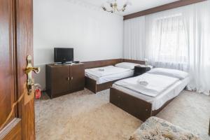 Postel nebo postele na pokoji v ubytování Hotel Bohemia