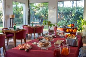 a dining room with a table with food on it at Hero's Garden Relais in Rome