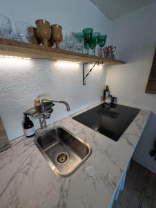 a kitchen with a sink and a counter top at Drängstugan Bärsta 5 in Kolbäck +72 photos