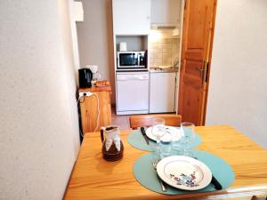 a wooden table with two plates on top of it at Les oulles 13 in La Chapelle-en-Valgodemard +2 photos