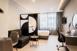 a hotel room with a bed and a couch at WYZ Museum by UPSTREET in Athens