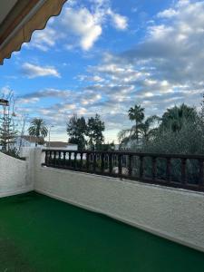 a balcony with a green floor and a fence at Casa Ángeles in Benicàssim