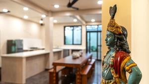 a statue of a woman in a room at Villa Vani in Mysore
