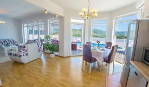 a living room with a table and chairs at Luxury Villa Horizon in Kosor