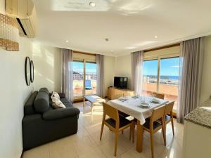a living room with a table and a couch at Apartamentos Mediterráneo Real in Fuengirola
