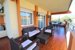 a living room with couches and a table and chairs at Chalet con piscina y barbacoa in Polop