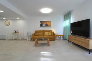 a living room with a couch and a flat screen tv at Apartamento Avenida Altea 19 in Altea