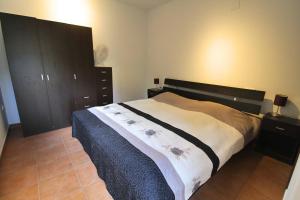 a bedroom with a large bed and wooden cabinets at Chalet a 500m del mar in Altea +18 photos